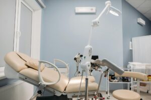 Salle de consultation gynécologique vide, stéthoscope posé sur un bureau médical